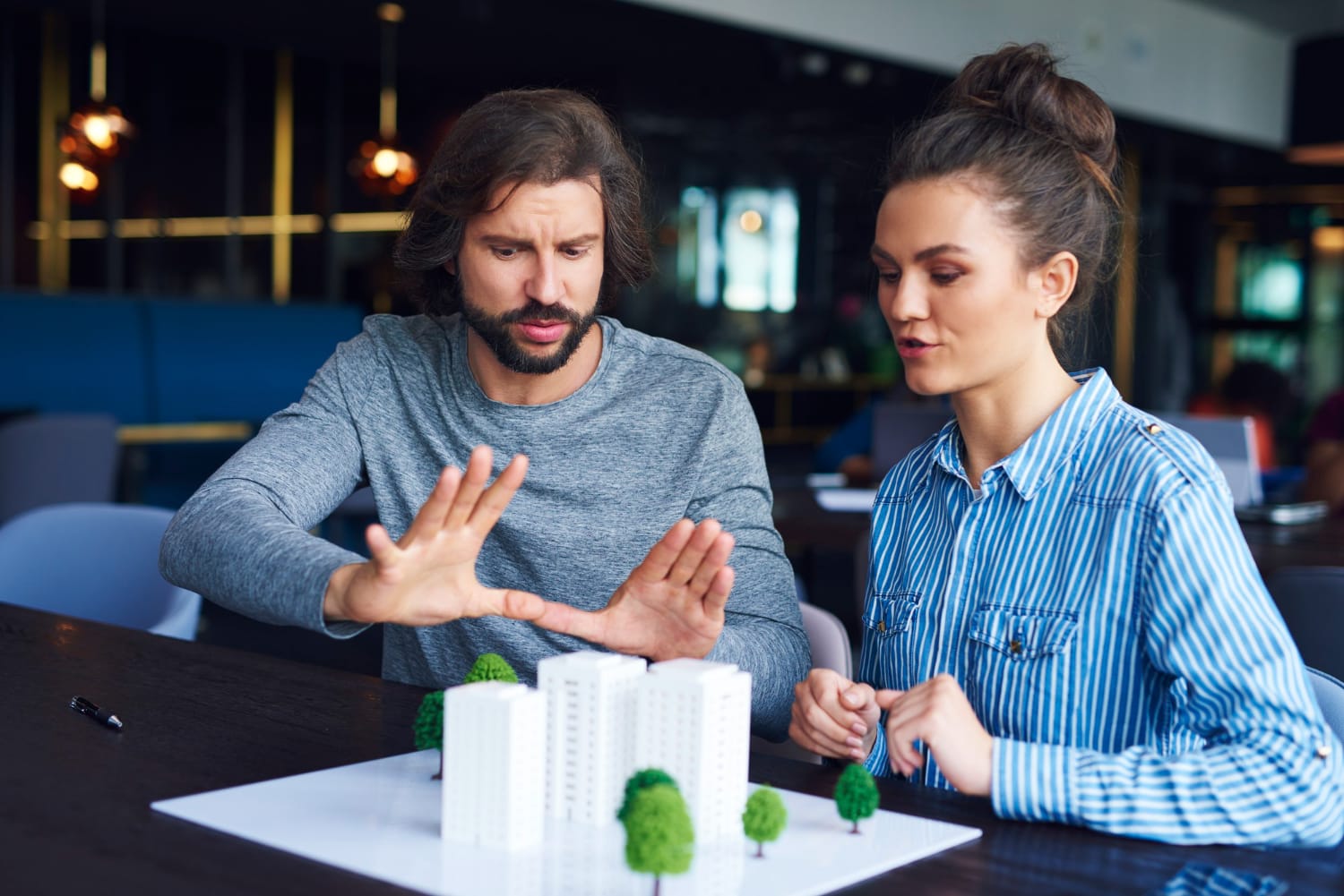 Two professionals discussing real estate investment strategies using AI in real estate investment