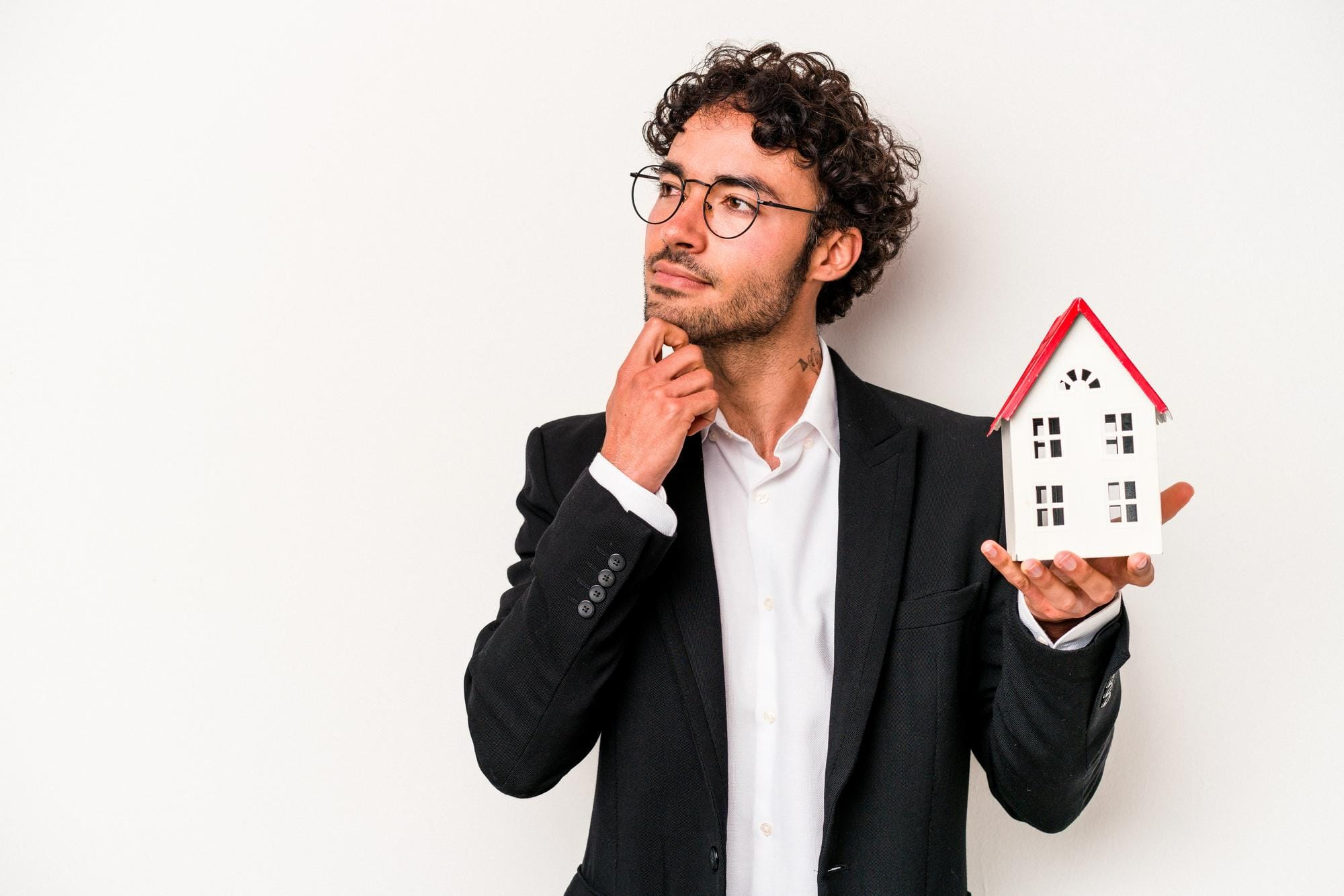 AI for Hard Money Lenders: 3 Marketing Ideas 3 A hard money lender in a suit thoughtfully holds a model house, representing the complex analysis that is enhanced and streamlined by AI.