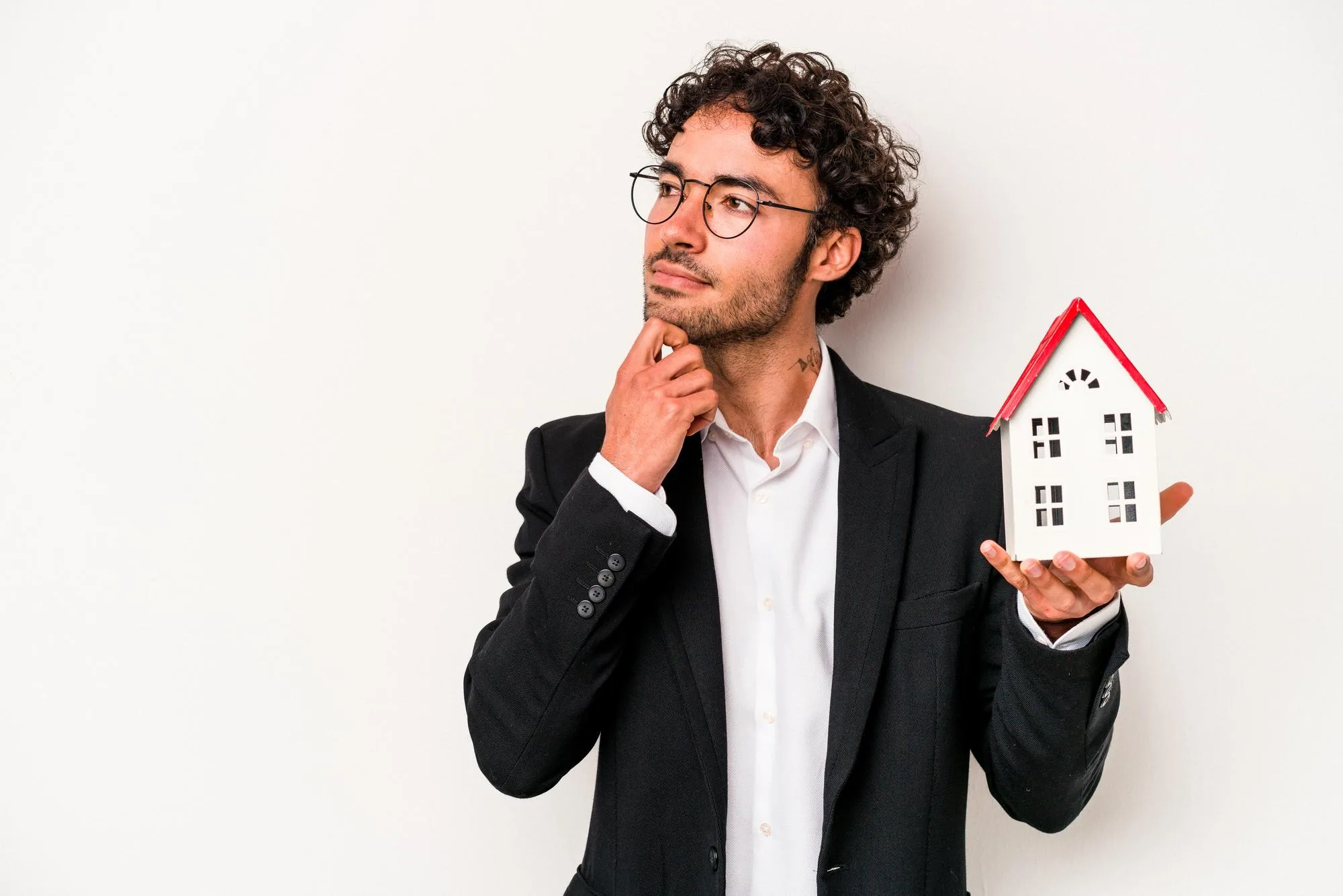 AI for Hard Money Lenders: 3 Marketing Ideas 3 A hard money lender in a suit thoughtfully holds a model house, representing the complex analysis that is enhanced and streamlined by AI.