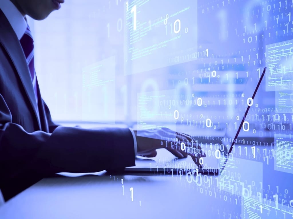 7 Best Investment Properties APIs for IT Developers in 2026 2 Professional using a laptop with digital code overlay representing data-driven real estate technology.