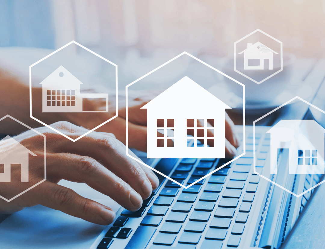 Real estate investor using laptop with digital property icons overlay for online rental property search and analysis