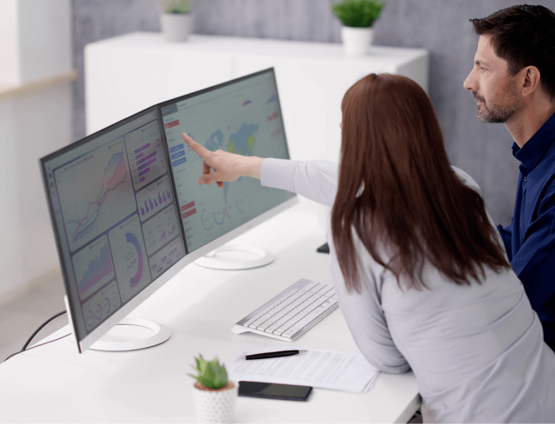 Real estate investors reviewing property data analytics and Real Estate Database API metrics on dashboard