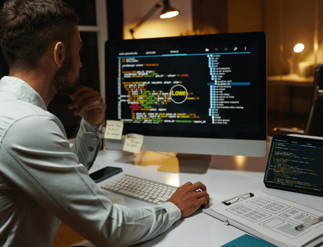 Developer implementing Real Estate Database API optimization strategies with code on desktop monitor