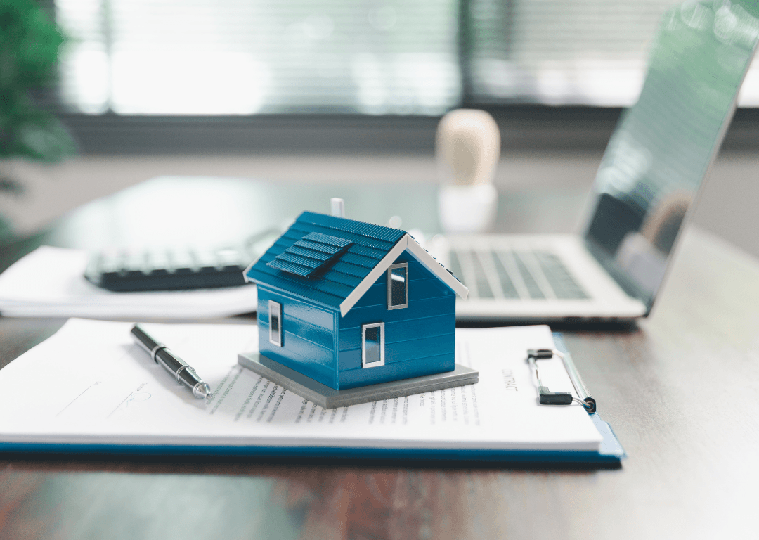 AI-powered investment property analysis with laptop and house model on contract documents
