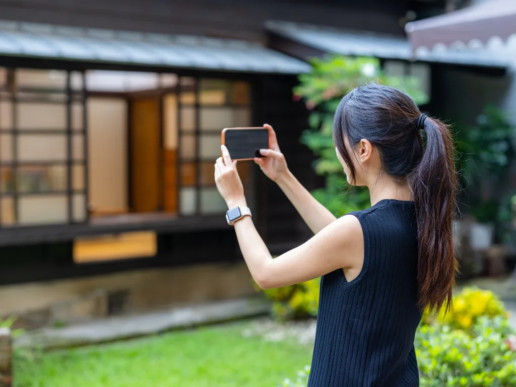 7 Platforms to Find Off-Market Properties 3 Real estate investor using smartphone to capture off-market property photos for AI analysis