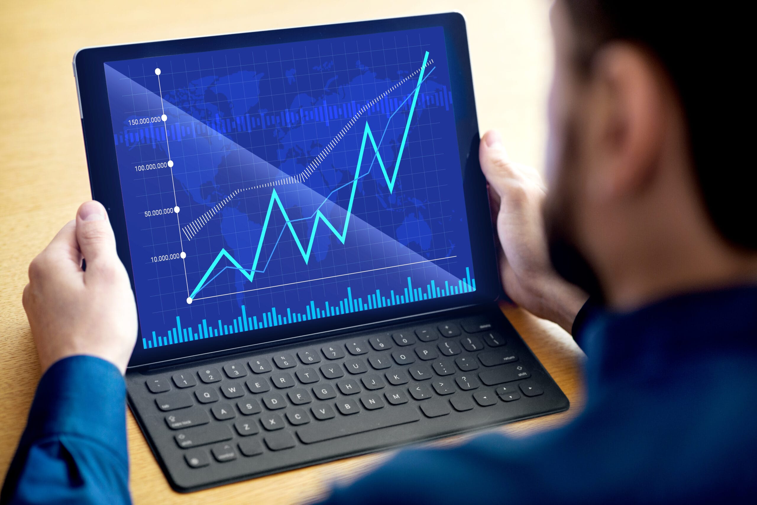 Lender reviewing AVM real estate data on tablet to assess property valuation accuracy
