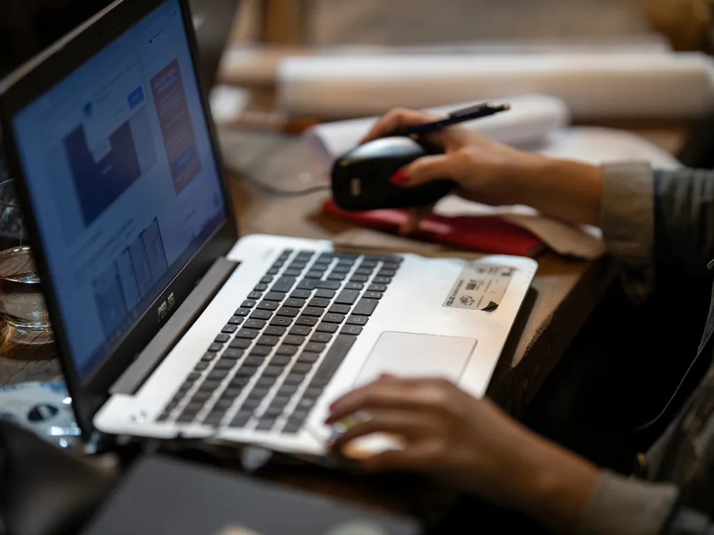 5 Best Browser Extensions for RE Investors 3 Real estate investor using browser extensions to analyze properties on a laptop