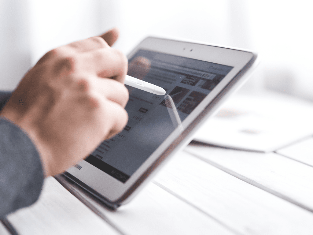 8 Best PropTech Companies for Investors 3 Investor analyzing real estate technology platform on a tablet device