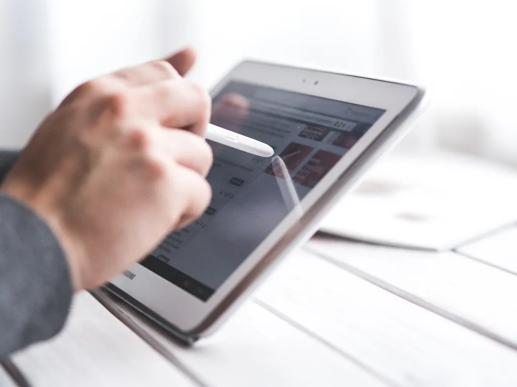 Investor analyzing real estate technology platform on a tablet device