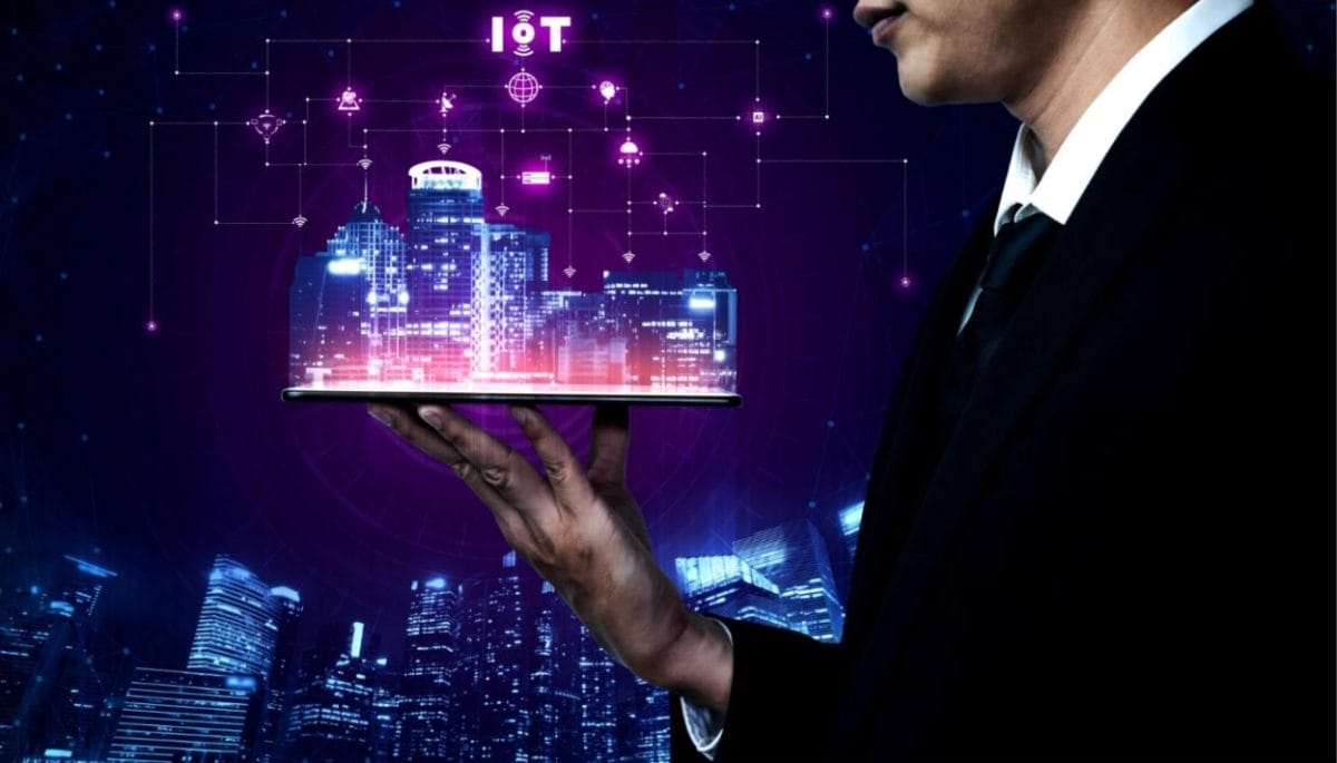 Businessman holding a tablet displaying a digital cityscape connected with AI 